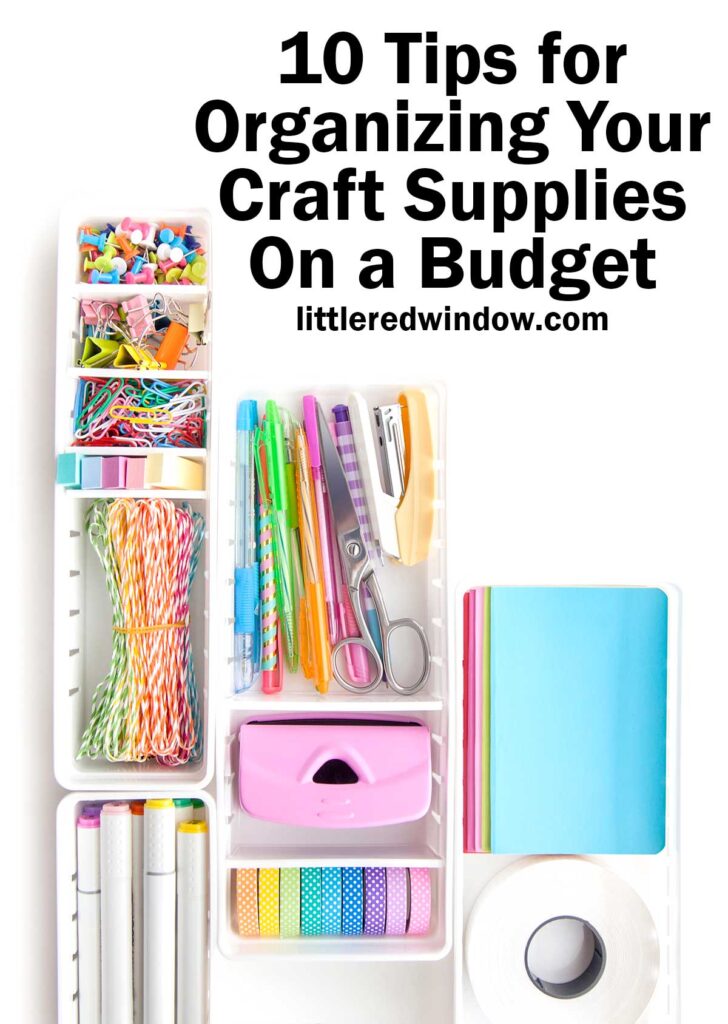 Top view of a white rectangular boxes filled with rainbow colored organized craft supplies on a white background