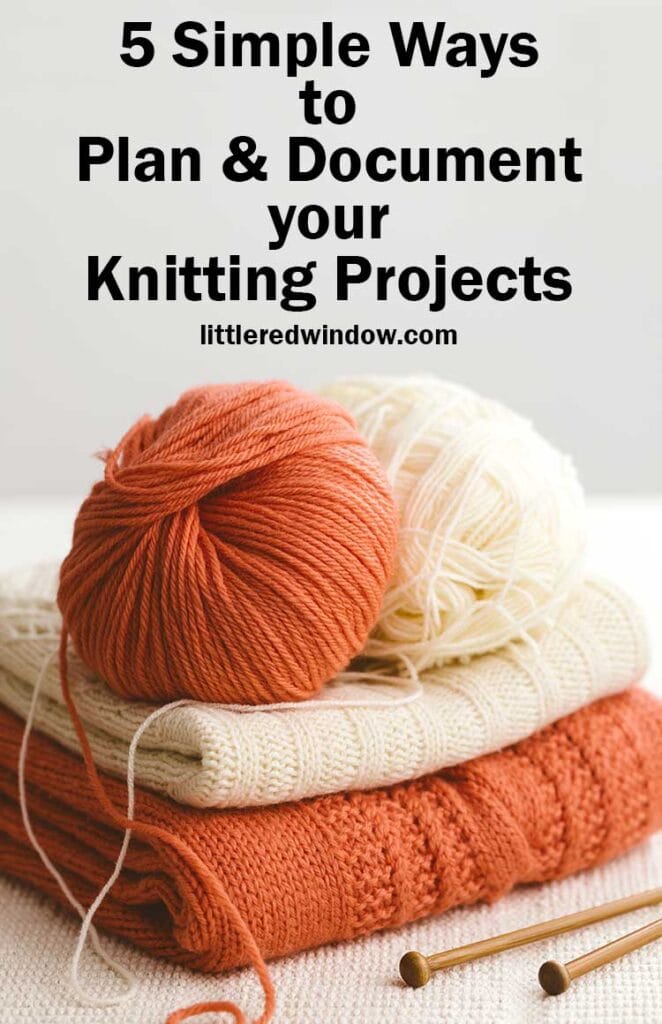 rust orange and white folded sweaters with matching balls of yarn on top and wood knitting needles below in front of a light gray background