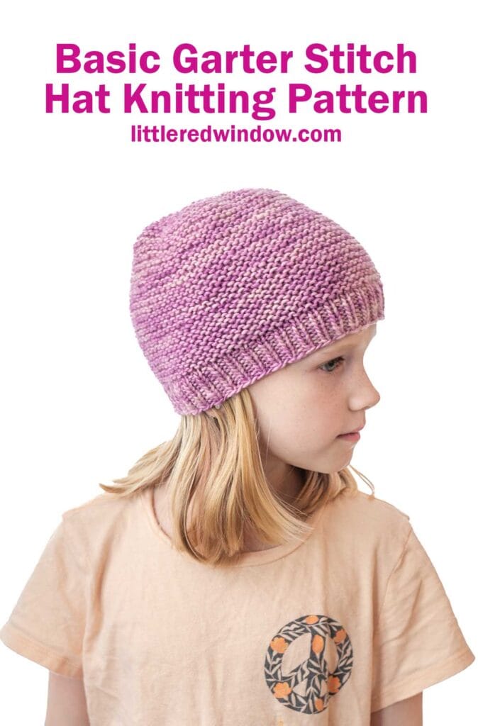 Young girl wearing a light pink and purple garter stitch hat, looking to the side. Above her, text reads: 