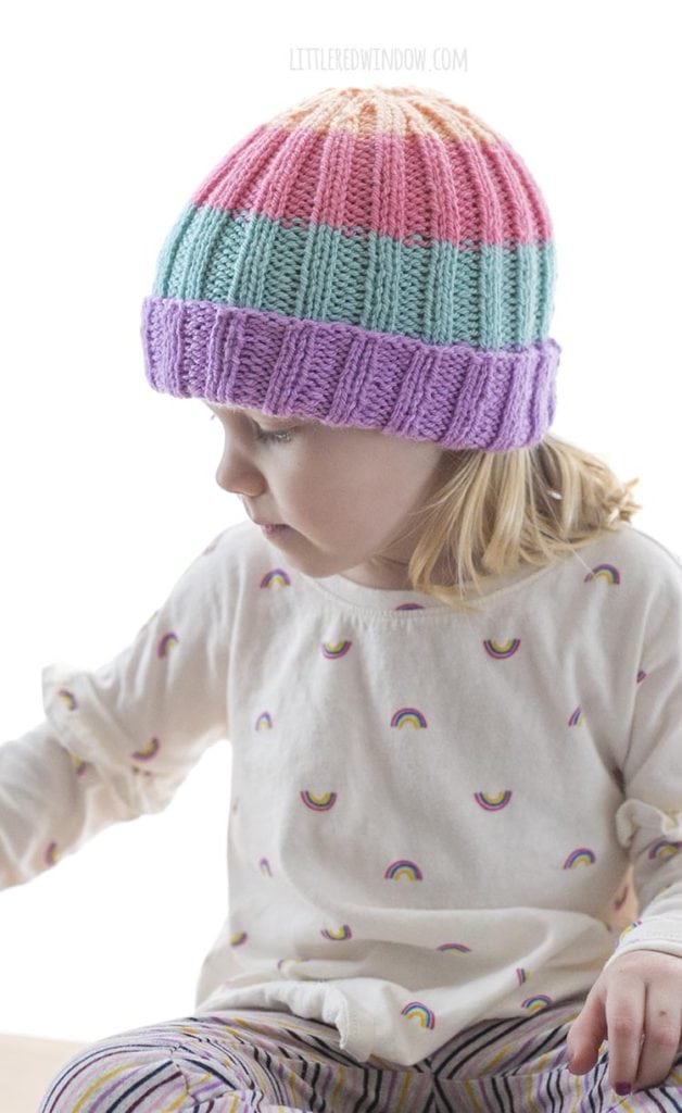 Little girl wearing sherbet hat and looking to the side