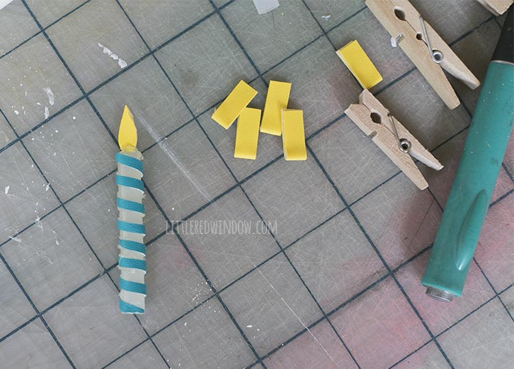 one faux leather yellow flame attached to the top of the birthday candle