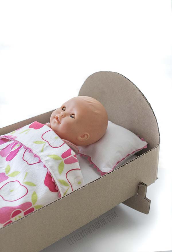 DIY Doll Crib from a cardboard box! This quick and easy craft will be a hit with your little one!