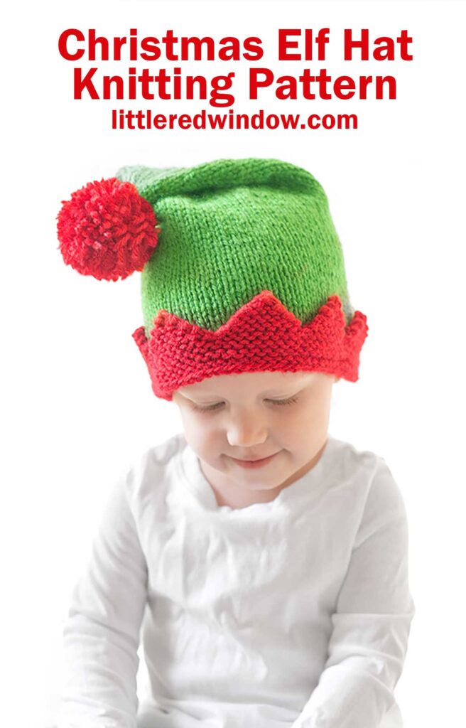 A child wearing a green and red knitted elf hat with a large red pom-pom smiles while gazing downward. Text above reads,