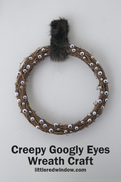 This quick and easy creepy google eyes wreath craft is the perfect Halloween craft to make for your home! Kids can help too!