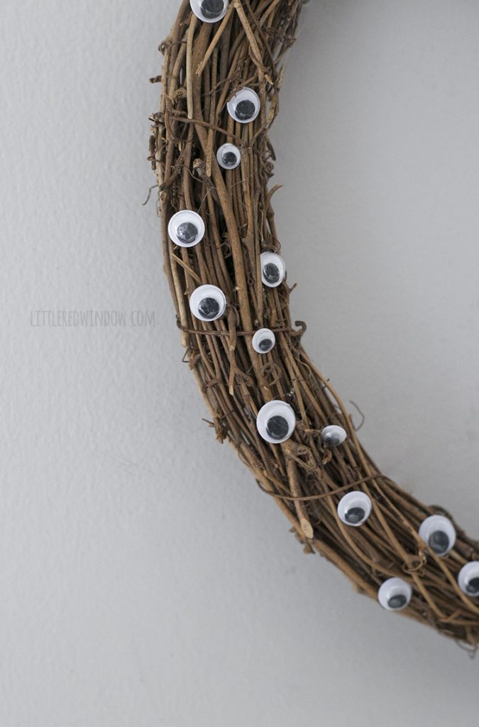 closeup of grapevine wreath fully of googly eyes