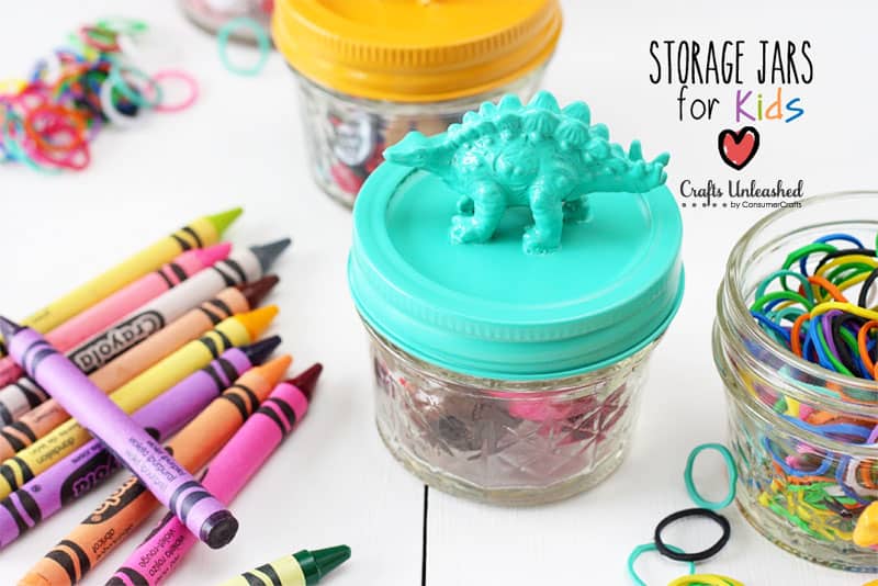 Small glass jar with blue painted lid and small dinosaur toy glued to the top as a handle