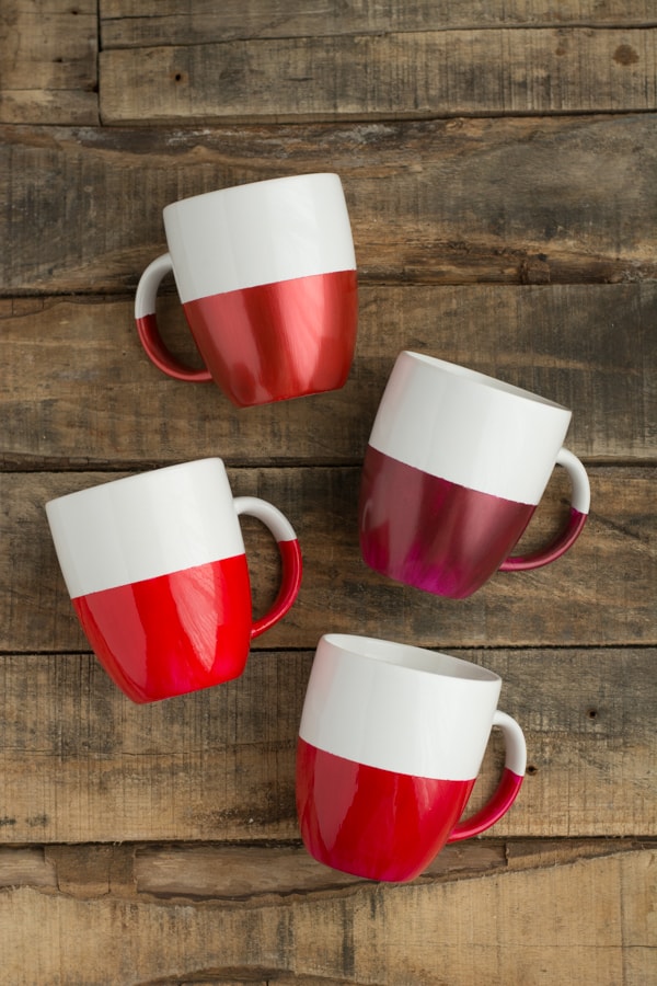 4 white coffee mugs with the bottom halves dippes in shades of red
