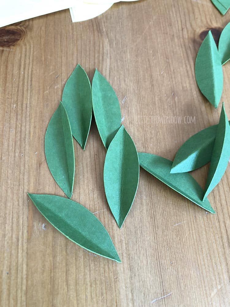 Fold the lemon leaves in half the long way to add dimension to your Lemon Wreath