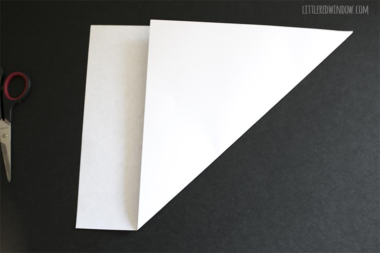 paper with one corner folded up to make a square