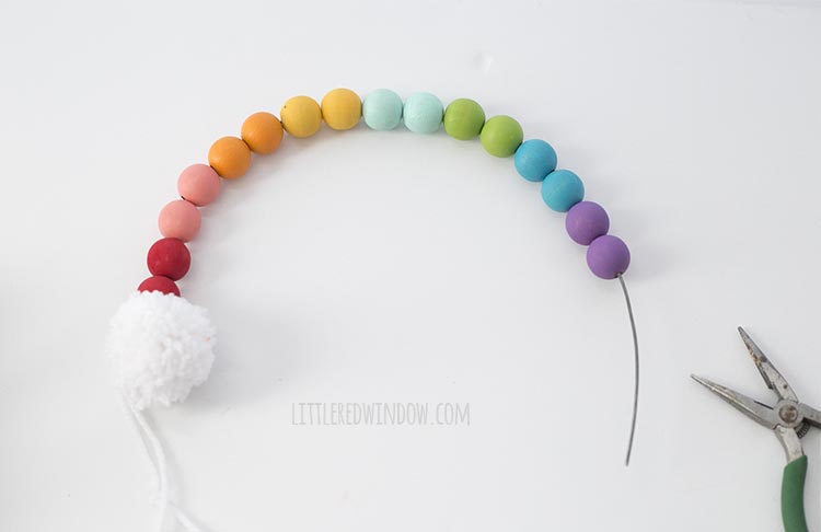 String the rainbow colored wooden beads on wire to make a rainbow shape!