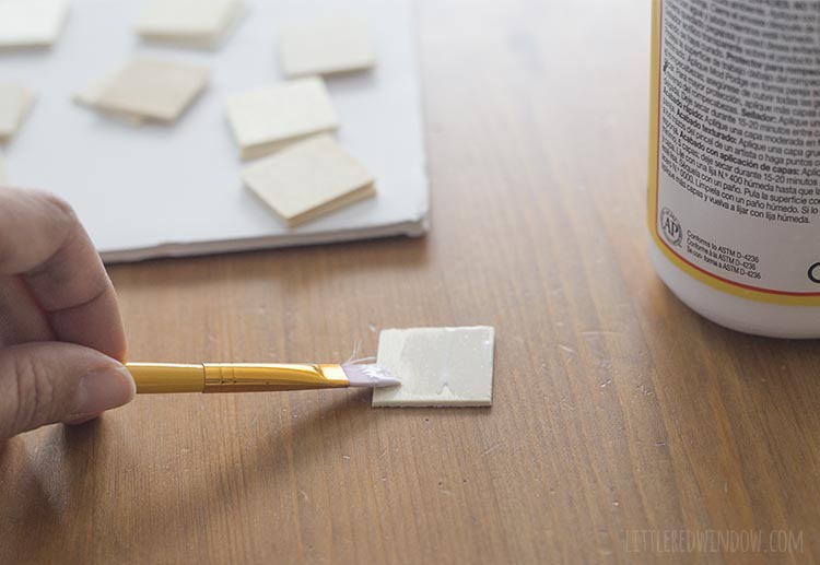 Use decoupage glue to decorate your DIY travel matching game tiles with fun colorful scrapbook paper