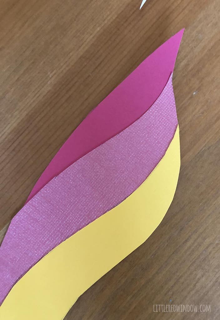 Trim off any excesses backing paper from the rainbow hair for your DIY unicorn mirror