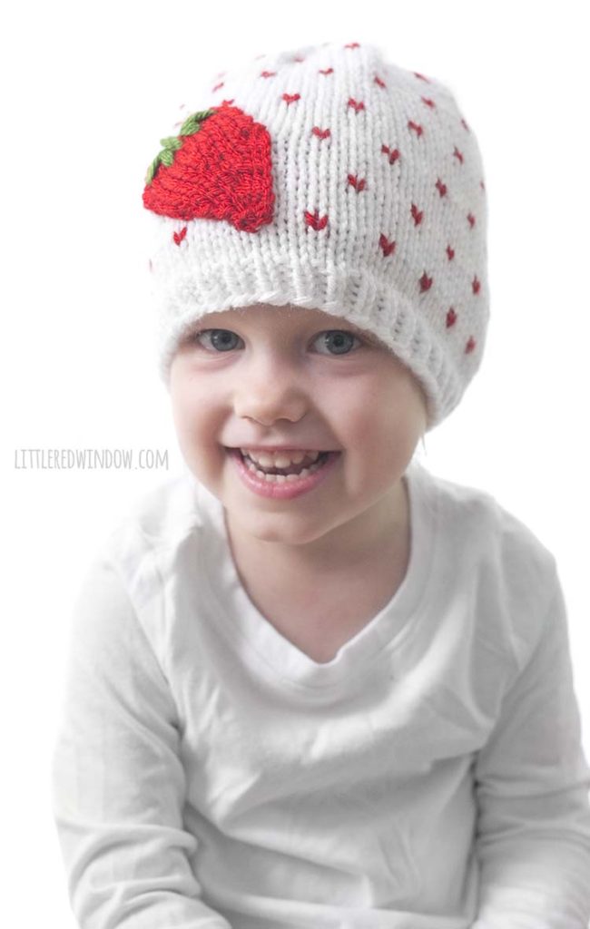 This little girl loves her Fresh Strawberry Hat, it's a fun and easy knitting pattern for babies and toddlers!