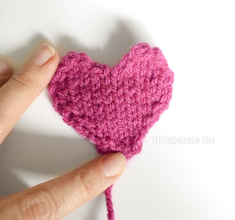 Be sure to block your knit heart shape before sewing it on to your gathered heart hat!