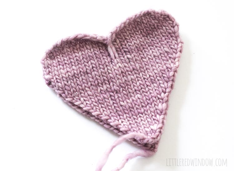 To assemble the heart shaped handwarmer knitting pattern, stack two heart shapes wrong sides together.