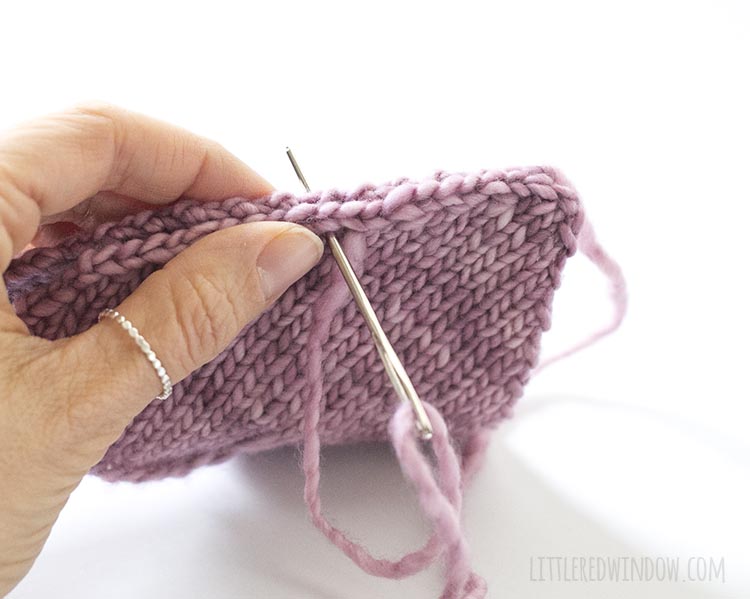 To assemble the heart shaped handwarmer knitting pattern, sew two heart shapes together with a yarn needle.