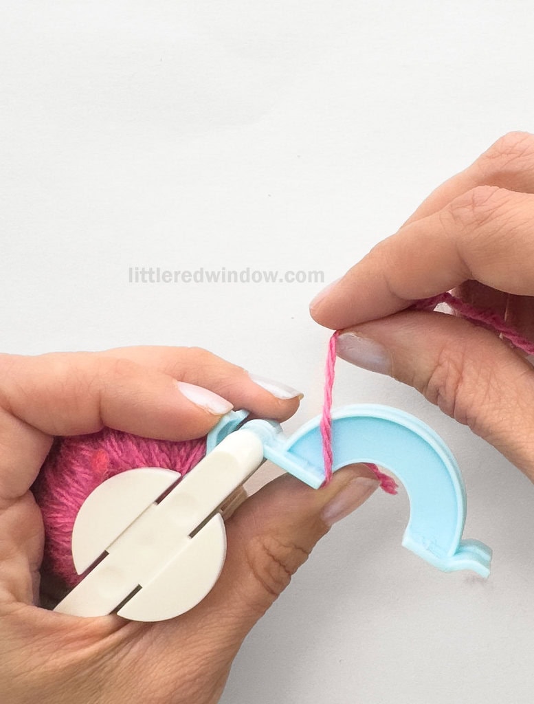 Being winding yarn around the arches from left to right and back again, keeping the yarn straight and evenly wound.
