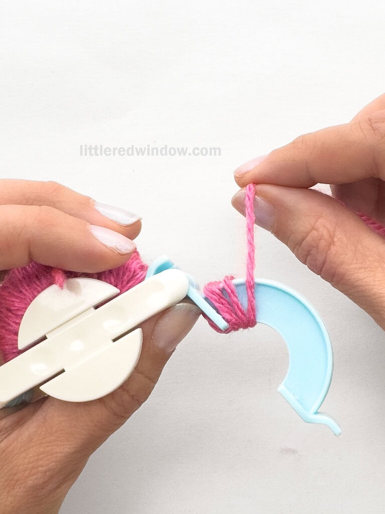 Being winding yarn around the arches from left to right and back again, keeping the yarn straight and evenly wound.