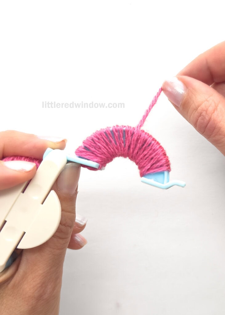 Being winding yarn around the arches from left to right and back again, keeping the yarn straight and evenly wound.