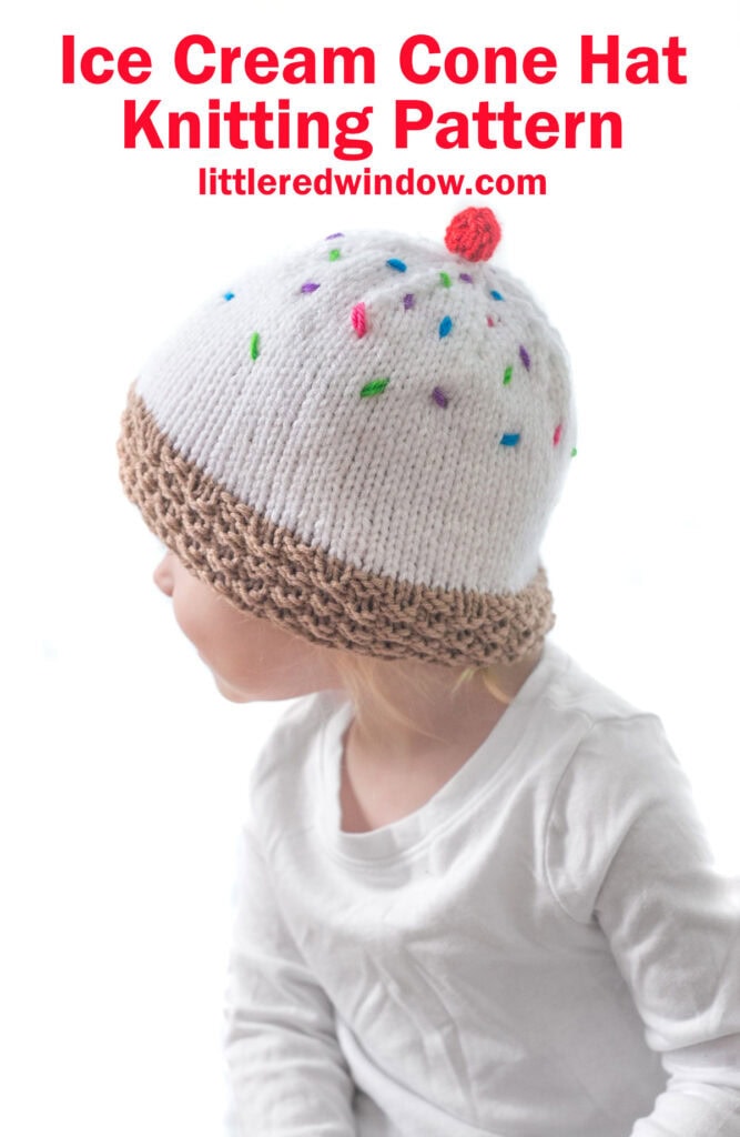 A child wearing an ice cream hat with a white knitted design resembling an ice cream cone, complete with a brown textured brim and multicolored sprinkles. The hat is topped with a red pom-pom. The text above reads 