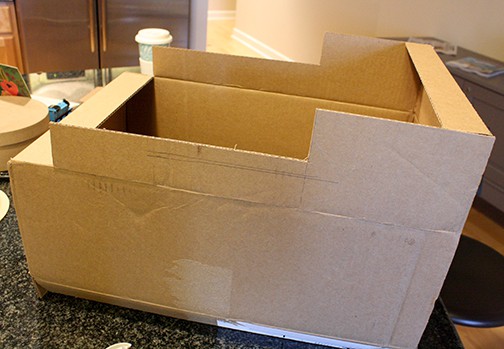 The top flaps of a cardboard box cut to make the shape of Thomas the Train