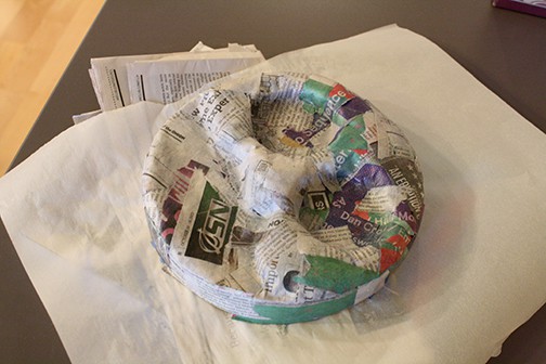 Lid of the round cardboard box with paper mache over it to make the 3d shape of Thomas the train's face