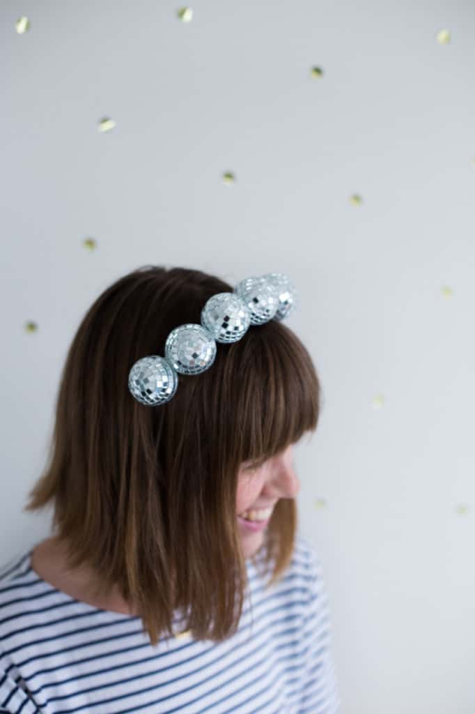 Woman wearing heaband made of small disco balls