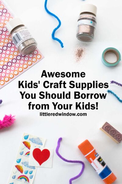 kids craft supplies including glue stick chenille stems glitter and stickers arranged in a circle on a white background