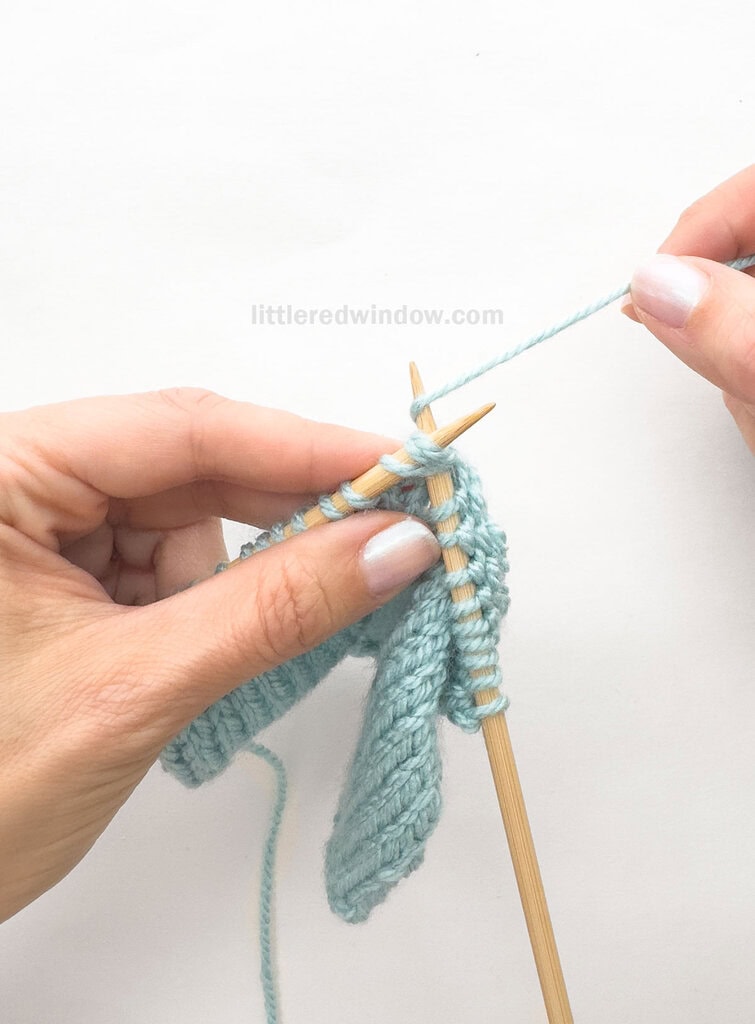 Wrap the working yarn around the tip of the right needle.