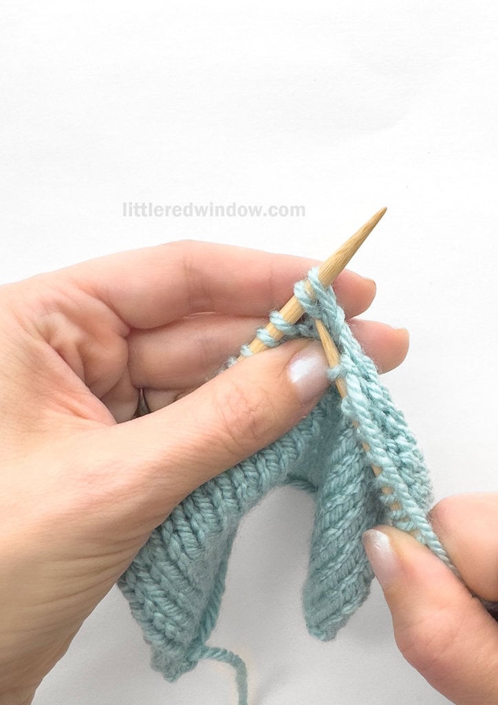 Skip the 1st stitch on the left needle and knit into the FRONT of the 2nd, leaving both stitches on the left needle.
