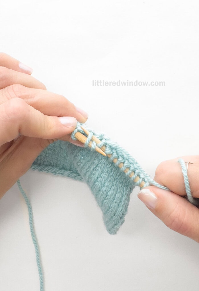 Skip the 1st stitch on the left needle and knit into the BACK of the 2nd, leaving both stitches on the left needle.