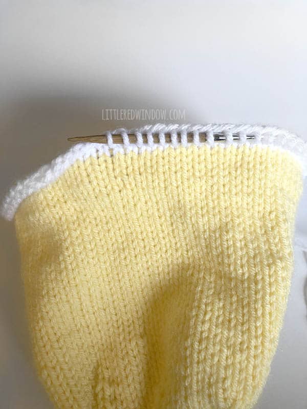 Pick up stitches to knit the eggshell brim on the Little Chick Baby Hat!