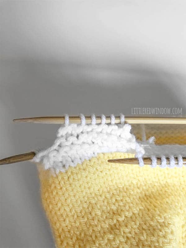 Work with short rows to knit the eggshell brim on this cute little chick baby hat knitting pattern!