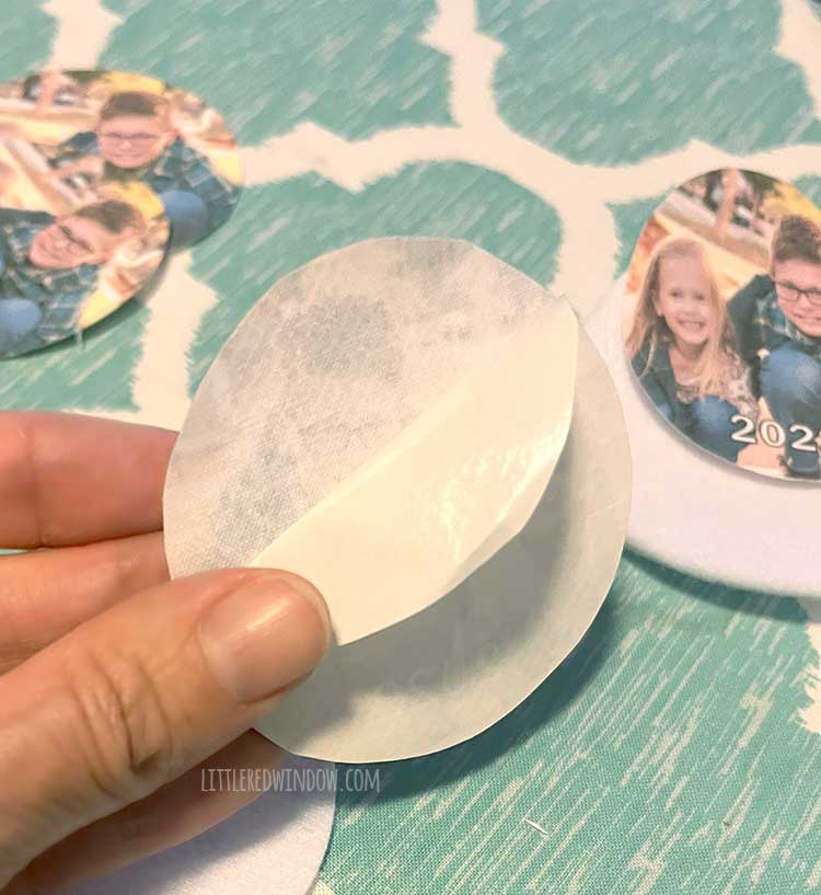 hand peeling the backing off a circle of fusible interfacing