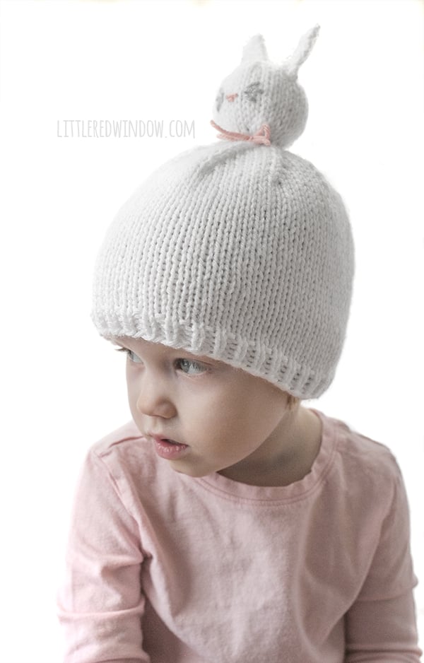 The Bunny Pom Pom Pet Hat knitting pattern is super fun to knit and your little one will love wearing it!