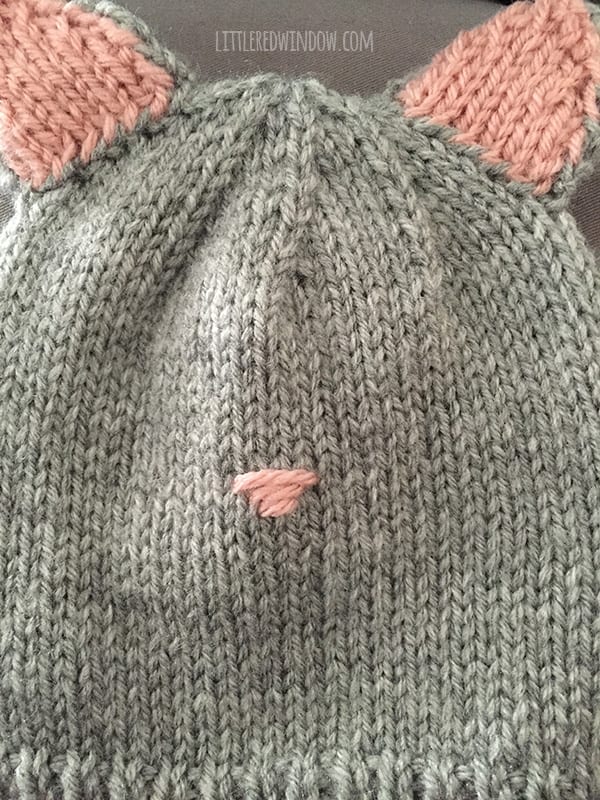 Image showing third horizontal stitch in pink yarn on the front of the cat hat