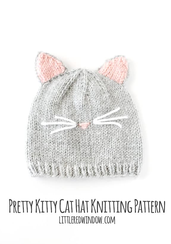 Flat lay view of a gray knit cat hat on a white background