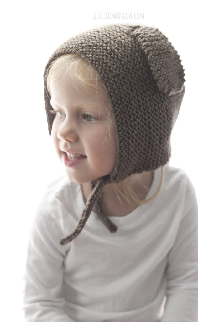 The puppy dog bonnet knitting pattern is knit in garter stitch and has two cute floppy puppy dog ears on the sides!