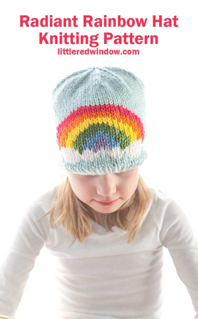 A child dons a charming light blue knitted hat adorned with a vibrant rainbow pattern. Above, the text declares: 