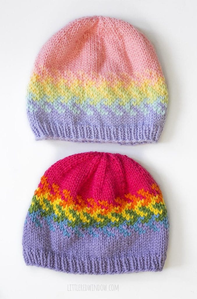 overhead view of two versions of the arrow fade rainbow fades hats knitting pattern one in pastel rainbow colors and one in bright rainbow colors