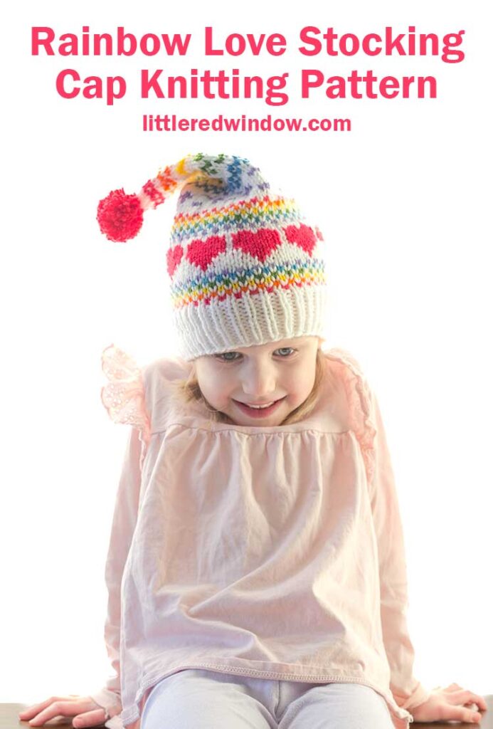 A child in a colorful stocking cap adorned with red hearts beams with joy. Above, the text reads, 