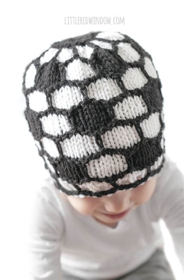 closeup of knit stitches on a black and white knit soccer ball hat