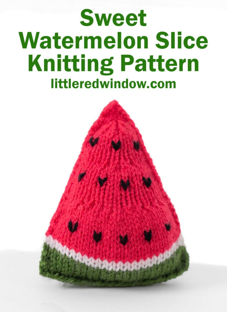 triangular knit watermelon slice with green rind and bright pink watermelon with black seeds from the front on a white background