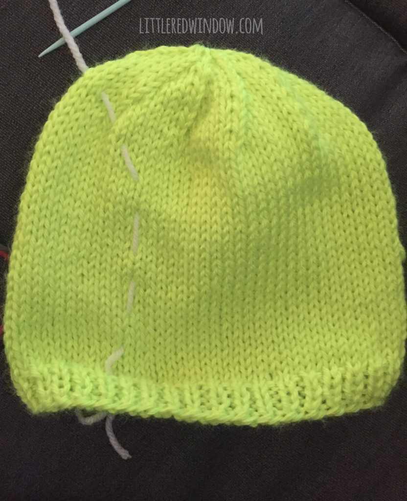 bright green tennis ball hat with a line of white basting stitches