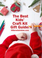 small Child writes the letter to Santa Claus. Child's hands, the sheet of paper, pencils and Christmas decorations on a wooden surface. Concept of New year and Christmas. Top view.