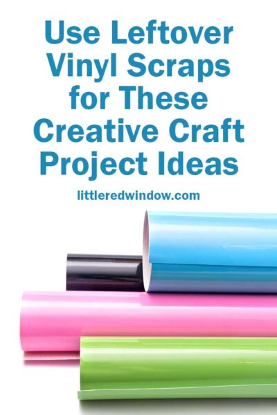 rolls of green pink blue and black adhesive craft vinyl stacked horizontally in front of a white background