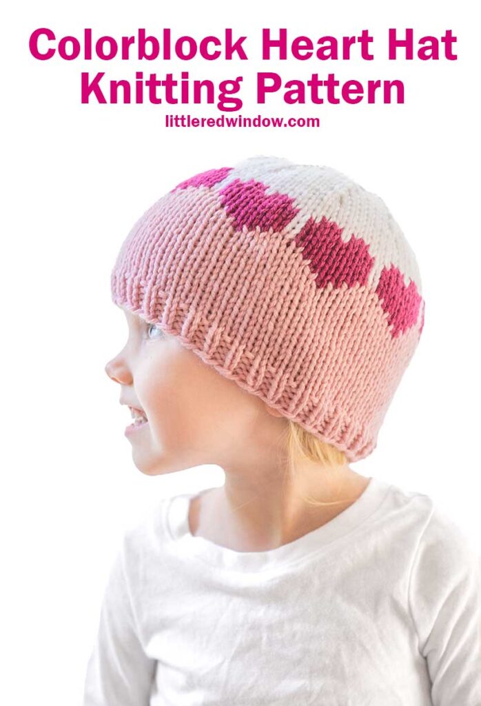 A young child dons a charming colorblock hat with pink and white hues, adorned with a lovely heart design. Glancing to the side in a crisp white shirt, they capture warmth and whimsy. Above reads,